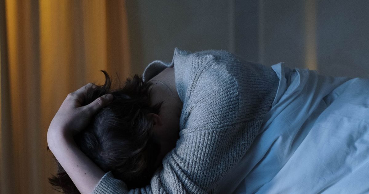Woman feeling drained and unfocused at her desk in the afternoon